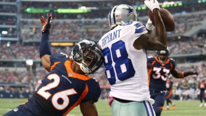 Oct 6, 2013; Arlington, TX, USA; Dallas Cowboys receiver Dez Bryant (88) catches a first quarter touchdown against Denver Broncos safety Rahim Moore (26) at AT&T Stadium. Mandatory Credit: Matthew Emmons-USA TODAY Sports