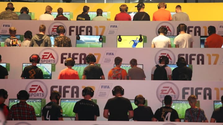COLOGNE, GERMANY - 2016/08/18: Visitors playing Fifa 17 at the EA Sports stand at the Gamescom fair. Gamescom the Worlds largest Gaming Fair.Gamescom is a trade fair for video games held annually at the Koelnmesse in Cologne. It is organised by the BIU. (Photo by Maik Boenisch/Pacific Press/LightRocket via Getty Images)