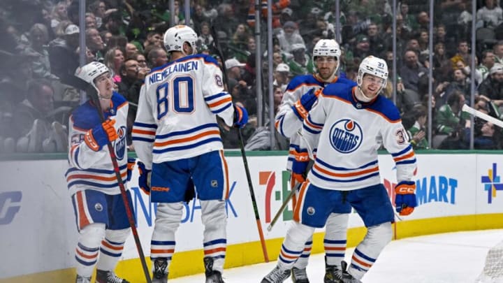 Dec 21, 2022; Dallas, Texas, USA; Edmonton Oilers right wing Kailer Yamamoto (56) and left wing Warren Foegele (37) and defenseman Markus Niemelainen (80) and defenseman Evan Bouchard (2) celebrate after Foegele scores a goal against the Dallas Stars during the third period at the American Airlines Center. Mandatory Credit: Jerome Miron-USA TODAY Sports