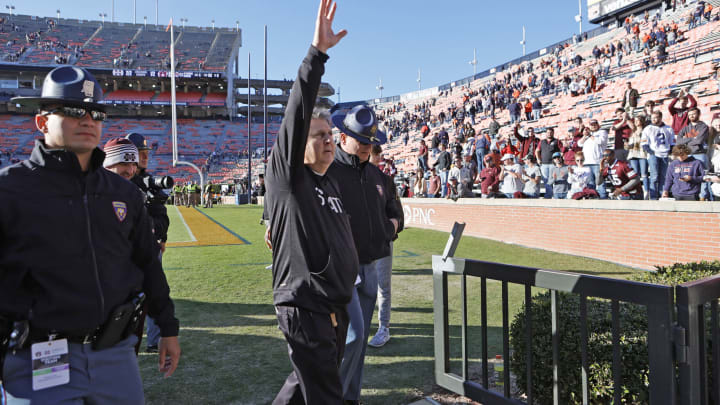 Former Mississippi State football coach Mike Leach waves to fans after beating the Auburn Tigers