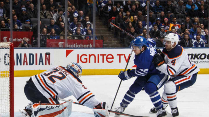 TORONTO, ON - FEBRUARY 27: Trevor Moore #42 of the Toronto Maple Leafs goes to the net against Kris Russell #4 of the Edmonton Oilers and Anthony Stolarz #32 during the third period at the Scotiabank Arena on February 27, 2019 in Toronto, Ontario, Canada. (Photo by Mark Blinch/NHLI via Getty Images)