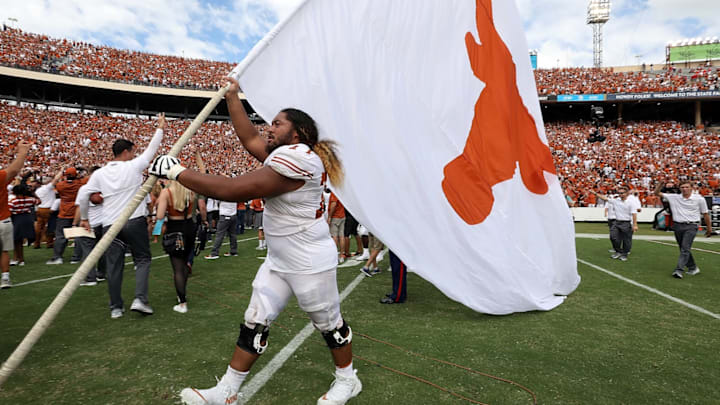 DALLAS, TX – OCTOBER 06: Patrick Vahe #77 of the Texas Longhorns carries a flag after a win against the Oklahoma Sooners in the 2018 AT&T Red River Showdown at Cotton Bowl on October 6, 2018 in Dallas, Texas. (Photo by Ronald Martinez/Getty Images)