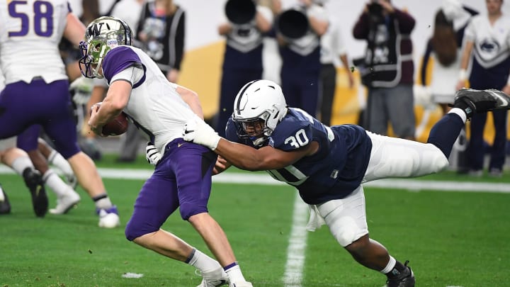 GLENDALE, AZ – DECEMBER 30: Kevin Givens #30 of the Penn State Nittany Lions grabs ahold of Jake Browning #3 of the Washington Huskies during the first half of the Playstation Fiesta Bowl at University of Phoenix Stadium on December 30, 2017 in Glendale, Arizona. (Photo by Norm Hall/Getty Images)