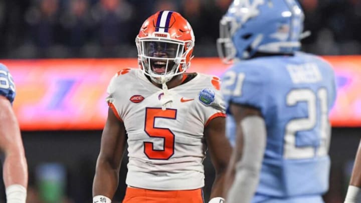 Clemson defensive end K.J. Henry (5) celebrates a defensive play near North Carolina defensive back Dontavius Nash (21) during the first quarter of the ACC Championship football game at Bank of America Stadium in Charlotte, North Carolina Saturday, Dec 3, 2022.Clemson Tigers Football Vs North Carolina Tar Heels Acc Championship Charlotte Nc