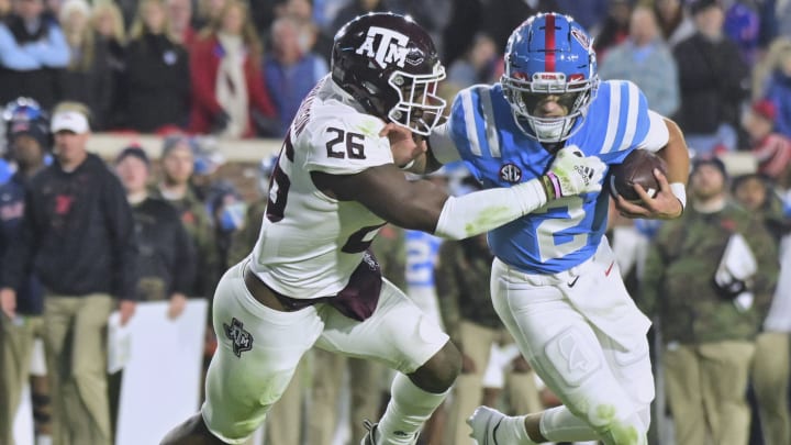 Nov 13, 2021; Oxford, Mississippi, USA; Mississippi Rebels quarterback Matt Corral (2) runs the ball against Texas A&M Aggies defensive back Demani Richardson (26) during the second quarter at Vaught-Hemingway Stadium. Mandatory Credit: Matt Bush-USA TODAY Sports