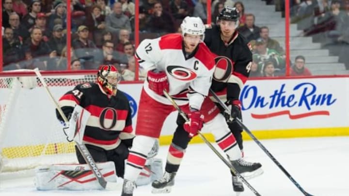 Feb 18, 2016; Ottawa, Ontario, CAN; Carolina Hurricanes center Eric Staal (12) and Ottawa Senators defenseman Patrick Wiercioch (46) watch the puck in the first period at the Canadian Tire Centre. Mandatory Credit: Marc DesRosiers-USA TODAY Sports