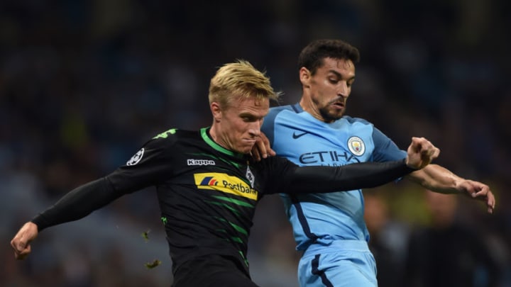 MANCHESTER, ENGLAND - SEPTEMBER 14: Oscar Wendt of VfL Borussia Moenchengladbach and Jesus Navas of Manchester City in action during the UEFA Champions League match between Manchester City FC and VfL Borussia Moenchengladbach at Etihad Stadium on September 14, 2016 in Manchester, England. (Photo by Visionhaus