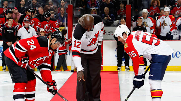 NEWARK, NJ - JANUARY 11: NBA great Shaquille O'Neal drops the ceremonial first puck between Bryce Salvador