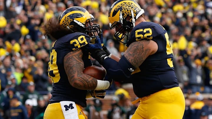 ANN ARBOR, MI - OCTOBER 17: Fullback Sione Houma #39 of the Michigan Wolverines celebrates with Mason Cole #52 after Houma scored a two yard rushing touchdown against the Michigan State Spartans during the second quarter of the college football game at Michigan Stadium on October 17, 2015 in Ann Arbor, Michigan. (Photo by Christian Petersen/Getty Images)