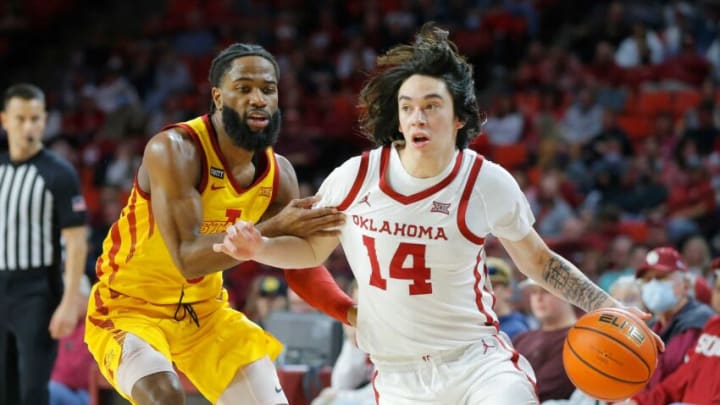 Oklahoma Sooners guard Bijan Cortes (14) goes past Iowa State Cyclones guard Tre Jackson (3) during a men's college basketball game between the University of Oklahoma Sooners (OU) and the Iowa State Cyclones at Lloyd Noble Center in Norman, Okla., Saturday, Jan. 8, 2022.Oklahoma Sooners Vs Iowa State Basketball