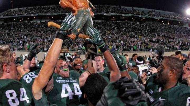 Oct 25, 2014; East Lansing, MI, USA; Michigan State Spartans defensive end Marcus Rush (44) holds up Paul Bunyan trophy after a game at Spartan Stadium. Mandatory Credit: Mike Carter-USA TODAY Sports