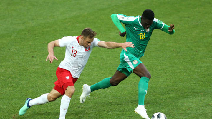 MOSCOW, RUSSIA - JUNE 19: Maciej Rybus of Poland battles for possession with Ismaila Sarr of Senegal during the 2018 FIFA World Cup Russia group H match between Poland and Senegal at Spartak Stadium on June 19, 2018 in Moscow, Russia. (Photo by Joosep Martinson - FIFA/FIFA via Getty Images)
