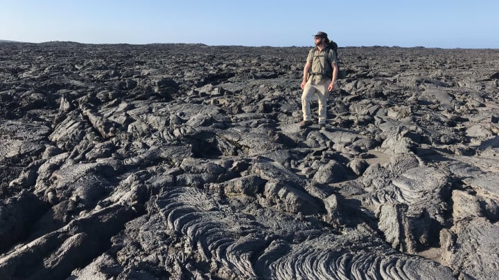 Forrest Galante Side Profile Standing On volcanic rock 02.. Extinct or Alive.. Image Courtesy Discovery