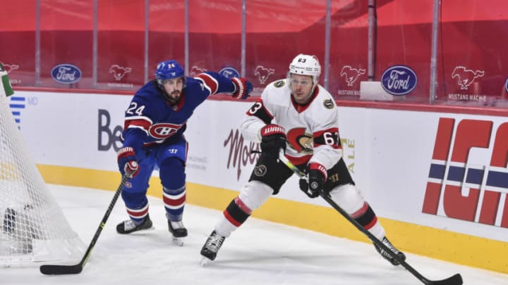 MONTREAL, QC - FEBRUARY 04: Evgenii Dadonov #63 of the Ottawa Senators skates the puck against Phillip Danault #24 of the Montreal Canadiens during the first period at the Bell Centre on February 4, 2021 in Montreal, Canada. (Photo by Minas Panagiotakis/Getty Images)