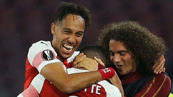 Arsenal's French striker Alexandre Lacazette (C) celebrates with Arsenal's Gabonese striker Pierre-Emerick Aubameyang (L) and Arsenal's French midfielder Matteo Guendouzi after opening the scoring during the UEFA Europa League quarter-final second leg football match Napoli vs Arsenal on April 18, 2019 at the San Paolo stadium in Naples. (Photo by Carlo Hermann / AFP) (Photo credit should read CARLO HERMANN/AFP/Getty Images)