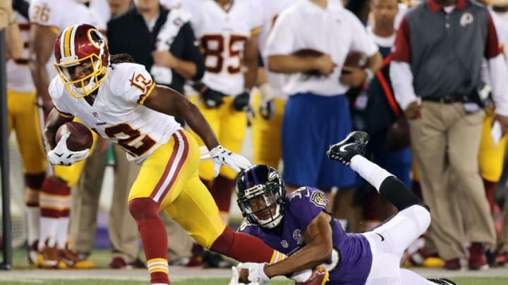 Aug 29, 2015; Baltimore, MD, USA; Washington Redskins wide receiver Andre Roberts (12) is tackled after catching a pass by Baltimore Ravens cornerback Rashaan Melvin (38) at M&T Bank Stadium. Mandatory Credit: Mitch Stringer-USA TODAY Sports