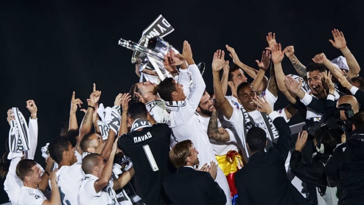 MADRID, SPAIN - MAY 29: Captain Sergio Ramos of Real Madrid CF holds the trophy behind Cristiano Ronaldo as they offer it to the audience surrounded by their teammates at Santiago Bernabeu Stadium the day after winning the UEFA Champions League Final match against Club Atletico de Madrid on May 29, 2016 in Madrid, Spain. Real Madrid CF is the only European football team with 11 European Cups (Photo by Gonzalo Arroyo Moreno/Getty Images)