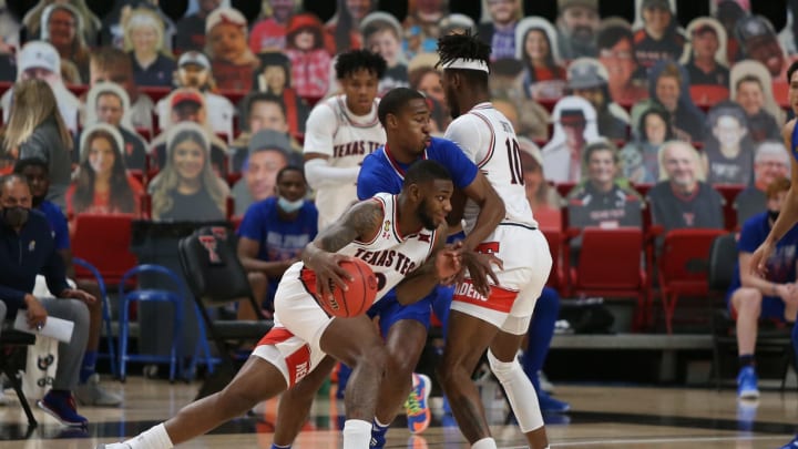 Dec 17, 2020; Lubbock, Texas, USA; Texas Tech Red Raiders guard Jamarius Burton (2) works the ball against Kansas Jayhawks guard Bryce Thompson (24) in the first half at United Supermarkets Arena. Mandatory Credit: Michael C. Johnson-USA TODAY Sports