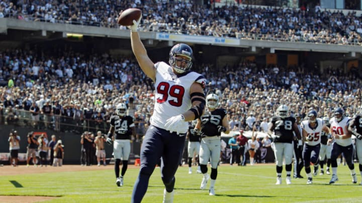 OAKLAND, CA - SEPTEMBER 14: J.J. Watt #99 of the Houston Texans celebrates after scoring a touchdown against the Oakland Raiders in the first quarter on September 14, 2014 at O.co Coliseum in Oakland, California. The Texans lead 17-0 in the second quarter. (Photo by Brian Bahr/Getty Images)