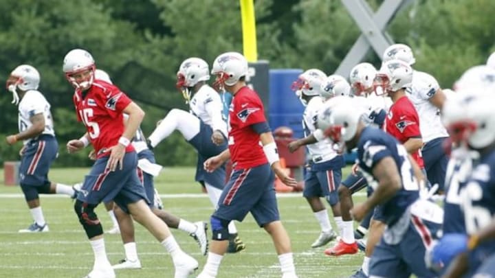 Jul 24, 2014; Foxborough, MA, USA; New England Patriots quarterback Ryan Mallet (15) talks with quarterback Tom Brady (12) while warming up during training camp at the team practice facility. Mandatory Credit: Stew Milne-USA TODAY Sports