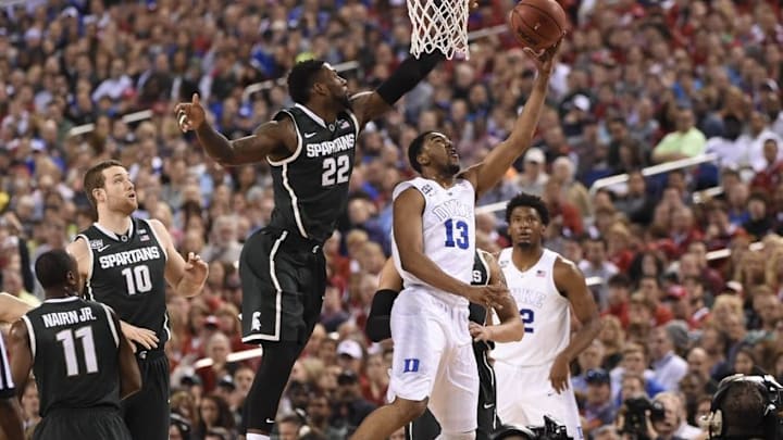 Apr 4, 2015; Indianapolis, IN, USA; Duke Blue Devils guard Matt Jones (13) lays the ball up past Michigan State Spartans guard/forward Branden Dawson (22) in the second half of the 2015 NCAA Men