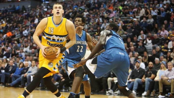 Dec 28, 2016; Denver, CO, USA; Denver Nuggets forward Nikola Jokic (15) spins towards the basket against Minnesota Timberwolves forward Gorgui Dieng (5) during the first half at Pepsi Center. Mandatory Credit: Chris Humphreys-USA TODAY Sports