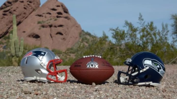Jan 28, 2015; Tempe, AZ, USA; General view of Seattle Seahawks and New England Patriots helmets and Super XLIX logo football at Papago Park. Mandatory Credit: Kirby Lee-USA TODAY Sports