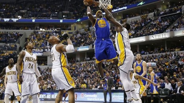 Mar 4, 2014; Indianapolis, IN, USA; Golden State Warriors center Jermaine O’Neal (7) takes a shot against Indiana Pacers center Roy Hibbert (55) at Bankers Life Fieldhouse. Mandatory Credit: Brian Spurlock-USA TODAY Sports