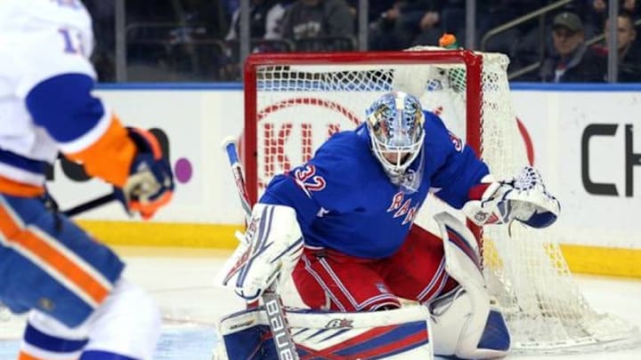 Mar 6, 2016; New York, NY, USA; New York Rangers goalie Antti Raanta (32) makes a save in front of New York Islanders left wing Josh Bailey (12) during the first period at Madison Square Garden. Mandatory Credit: Brad Penner-USA TODAY Sports