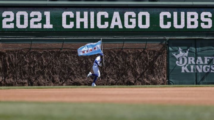 Apr 1, 2021; Chicago, Illinois, USA; Chicago Cubs right fielder Jason Heyward (22) arrives on the field with a Chicago city flag before an MLB game against the Pittsburgh Pirates at Wrigley Field. Mandatory Credit: Kamil Krzaczynski-USA TODAY Sports