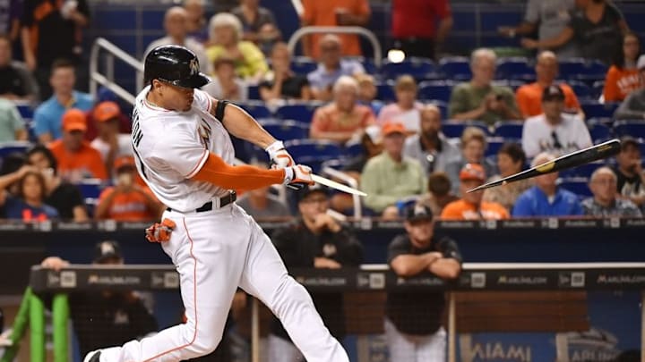 Aug 9, 2016; Miami, FL, USA; Miami Marlins right fielder Giancarlo Stanton (27) breaks his bat on a RBI double in the first inning off of San Francisco Giants starting pitcher Matt Moore (not pictured) at Marlins Park. Mandatory Credit: Jasen Vinlove-USA TODAY Sports