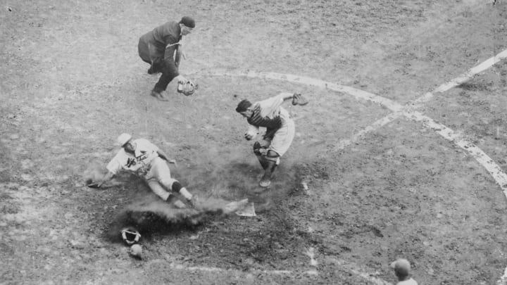 Cardinal star Pepper Martin slides around a tag attempt by Mickey Cochrane during the 1931 World Series. (Photo by Mark Rucker/Transcendental Graphics, Getty Images)