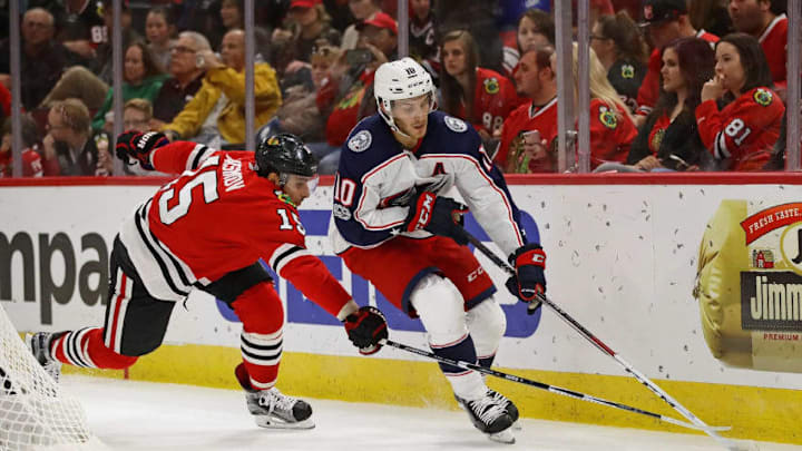 CHICAGO, IL - SEPTEMBER 23: Alexander Wennberg #10 of the Columbus Blue Jackets is pressured by Artem Anisimov #15 of the Chicago Blackhawks during a preseason game at the United Center on September 23, 2017 in Chicago, Illinois. (Photo by Jonathan Daniel/Getty Images)