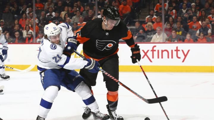 PHILADELPHIA, PA - JANUARY 11: Brayden Point #21 of the Tampa Bay Lightning battles for the puck against Philippe Myers #5 of the Philadelphia Flyers in the second period at the Wells Fargo Center on January 11, 2020 in Philadelphia, Pennsylvania. (Photo by Mitchell Leff/Getty Images)