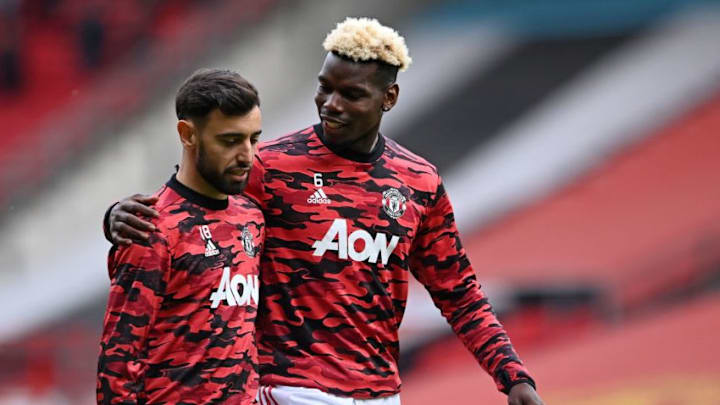 Manchester United's French midfielder Paul Pogba (R) hugs Manchester United's Portuguese midfielder Bruno Fernandes as they warm up ahead of the English Premier League football match between Manchester United and Fulham at Old Trafford in Manchester, north west England, on May 18, 2021. - RESTRICTED TO EDITORIAL USE. No use with unauthorized audio, video, data, fixture lists, club/league logos or 'live' services. Online in-match use limited to 120 images. An additional 40 images may be used in extra time. No video emulation. Social media in-match use limited to 120 images. An additional 40 images may be used in extra time. No use in betting publications, games or single club/league/player publications. (Photo by Laurence Griffiths / POOL / AFP) / RESTRICTED TO EDITORIAL USE. No use with unauthorized audio, video, data, fixture lists, club/league logos or 'live' services. Online in-match use limited to 120 images. An additional 40 images may be used in extra time. No video emulation. Social media in-match use limited to 120 images. An additional 40 images may be used in extra time. No use in betting publications, games or single club/league/player publications. / RESTRICTED TO EDITORIAL USE. No use with unauthorized audio, video, data, fixture lists, club/league logos or 'live' services. Online in-match use limited to 120 images. An additional 40 images may be used in extra time. No video emulation. Social media in-match use limited to 120 images. An additional 40 images may be used in extra time. No use in betting publications, games or single club/league/player publications. (Photo by LAURENCE GRIFFITHS/POOL/AFP via Getty Images)