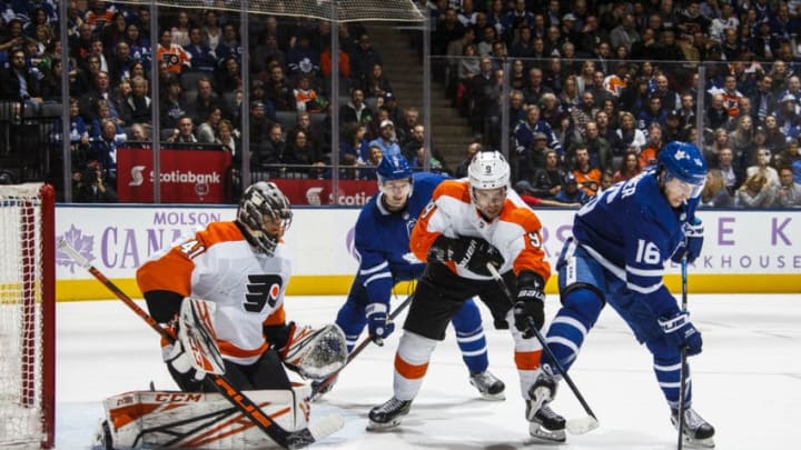 TORONTO, ON - NOVEMBER 24: Mitch Marner #16 of the Toronto Maple Leafs battles in front of the net against Ivan Provorov #9 of the Philadelphia Flyers during the second period at the Scotiabank Arena on November 24, 2018 in Toronto, Ontario, Canada. (Photo by Kevin Sousa/NHLI via Getty Images)