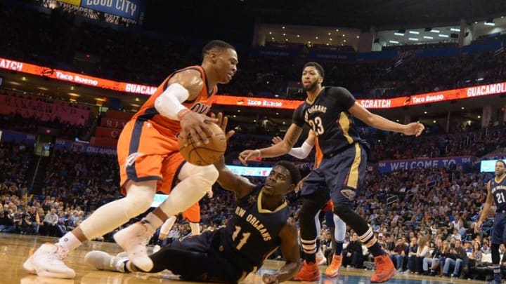 Dec 4, 2016; Oklahoma City, OK, USA; Oklahoma City Thunder guard Russell Westbrook (0) drives to the basket in front of New Orleans Pelicans guard Jrue Holiday (11) and New Orleans Pelicans forward Anthony Davis (23) during the fourth quarter at Chesapeake Energy Arena. Mandatory Credit: Mark D. Smith-USA TODAY Sports