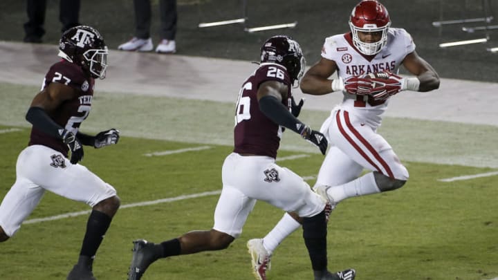 COLLEGE STATION, TEXAS - OCTOBER 31: Treylon Burks #16 of the Arkansas Razorbacks runs after a reception in the second quarter defended by Demani Richardson #26 of the Texas A&M Aggies at Kyle Field on October 31, 2020 in College Station, Texas. (Photo by Tim Warner/Getty Images)