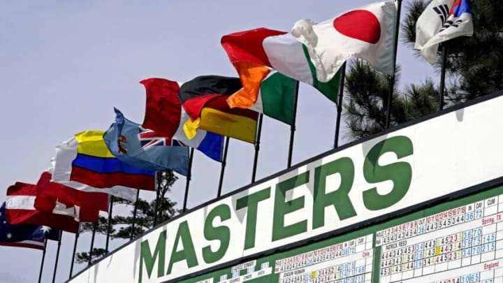 Apr 11, 2021; Augusta, Georgia, USA; World flags fly over a leaderboard during the final round of The Masters golf tournament. Mandatory Credit: Rob Schumacher-USA TODAY Sports