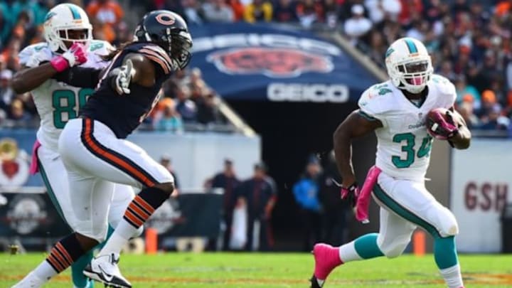 Oct 19, 2014; Chicago, IL, USA; Miami Dolphins running back Damien Williams (34) rushes the ball against the Chicago Bears during the first half at Soldier Field. Mandatory Credit: Mike DiNovo-USA TODAY Sports
