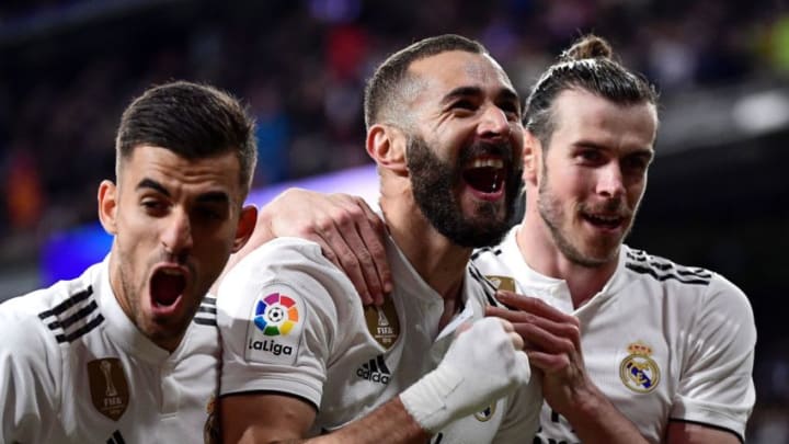 Real Madrid's French forward Karim Benzema celebrates with Real Madrid's Welsh forward Gareth Bale (R) and Real Madrid's Spanish midfielder Daniel Ceballos (L) after scoring his team's third goal during the Spanish League football match between Real Madrid CF and SD Huesca at the Santiago Bernabeu stadium in Madrid on March 31, 2019. (Photo by JAVIER SORIANO / AFP) (Photo credit should read JAVIER SORIANO/AFP/Getty Images)