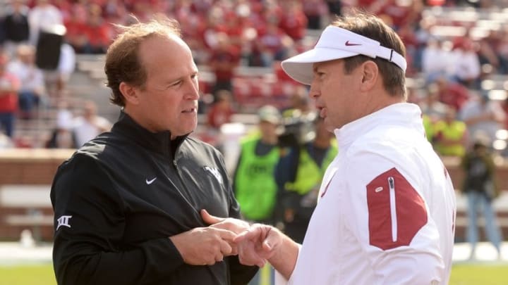 Oct 3, 2015; Norman, OK, USA; West Virginia Mountaineers head coach Dana Holgorsen speaks to Oklahoma Sooners head coach Bob Stoops prior to action at Gaylord Family - Oklahoma Memorial Stadium. Mandatory Credit: Mark D. Smith-USA TODAY Sports