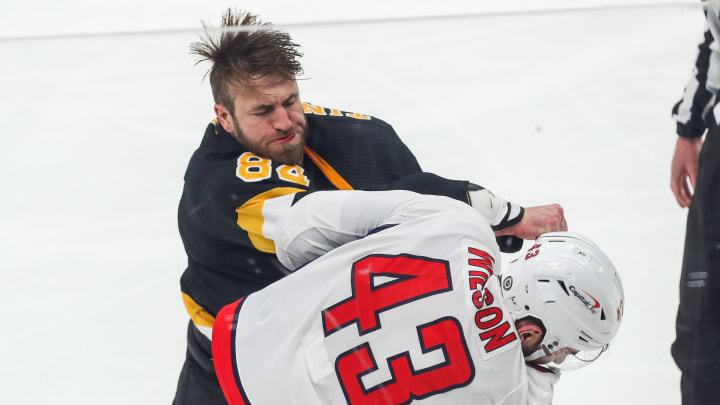 Mar 5, 2021; Boston, Massachusetts, USA; Boston Bruins defenseman Jarred Tinordi (84) punches Washington Capitals right wing Tom Wilson (43) during the second period at TD Garden. Mandatory Credit: Paul Rutherford-USA TODAY Sports