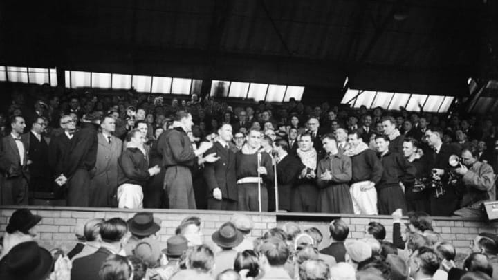 The Chelsea team applaud their captain, Roy Bentley, as he addresses the crowd after a win over Sheffield Wednesday at Stamford Bridge, 23rd April 1955. Chelsea's victory secured them the League Championship for the first time. (Photo by Reg Birkett/Keystone/Hulton Archive/Getty Images)