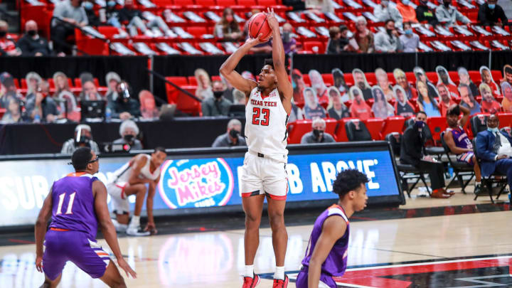 LUBBOCK, TEXAS – NOVEMBER 25: Guard Chibuzo Agbo #23 of the Texas Tech Red Raiders shoots a three-pointer during the second half of the college basketball game against the Northwestern State Demons at United Supermarkets Arena on November 25, 2020 in Lubbock, Texas. (Photo by John E. Moore III/Getty Images)
