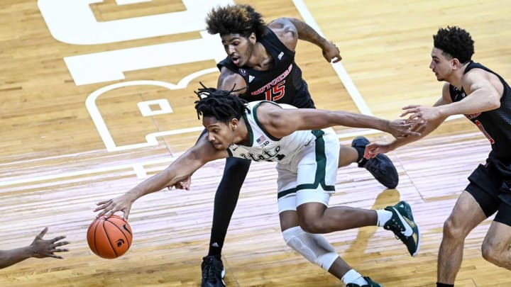 Michigan State’s A.J. Hoggard, left, is pressured by Rutgers’ Myles Johnson, center, and Geo Baker during the first half on Tuesday, Jan. 5, 2021, at the Breslin Center in East Lansing.210105 Msu Rutgers 033a