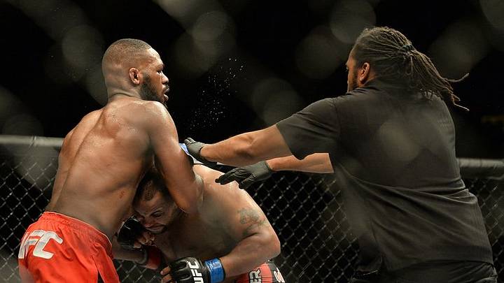 Jan 3, 2015; Las Vegas, NV, USA; Official referee Herb Dean separates Jon Jones (red gloves) and Daniel Cormier (blue gloves) as they fight after the buzzer to end their light heavyweight title fight at UFC 182 at the MGM Grand Garden Arena. Jones won. Mandatory Credit: Jayne Kamin-Oncea-USA TODAY Sports