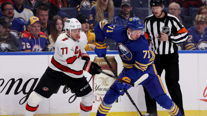 Apr 5, 2022; Buffalo, New York, USA; Buffalo Sabres left wing Victor Olofsson (71) takes the puck from Carolina Hurricanes defenseman Tony DeAngelo (77) during the second period at KeyBank Center. Mandatory Credit: Timothy T. Ludwig-USA TODAY Sports