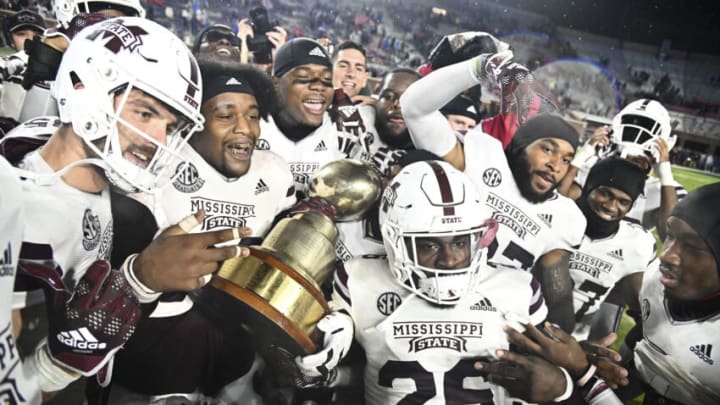 Nov 24, 2022; Oxford, Mississippi, USA; Mississippi State Bulldogs players celebrate with the Egg Bowl trophy after the game against the Ole Miss Rebels at Vaught-Hemingway Stadium. Mandatory Credit: Matt Bush-USA TODAY Sports