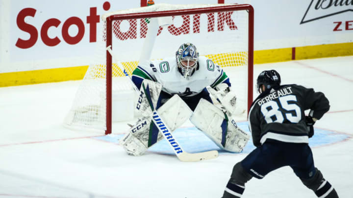 Mar 2, 2021; Winnipeg, Manitoba, CAN; Winnipeg Jets forward Matthieu Perreault (85) skates in against Vancouver Canucks goalie Braden Holtby (49) during the third period at Bell MTS Place. Mandatory Credit: Terrence Lee-USA TODAY Sport